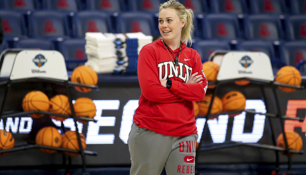 UNLV coach Lindy La Rocque smiles while watching the team shoot layups during practice for the NCAA women's college basketball tournament in Tucson, Ariz., March 18, 2022. (Rebecca Sasnett/Arizona Daily Star via AP)