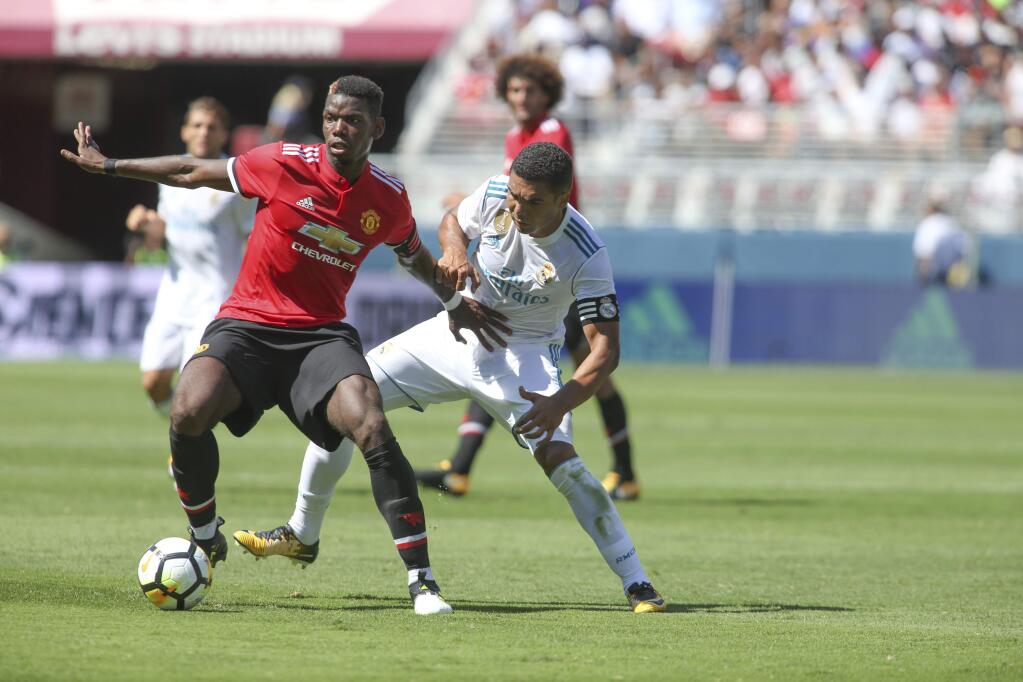 Paul Pogba of Manchester United keeps the ball away from a Real Madrid player during the International Champions Cup at Levi's Stadium on Sunday, July 23, 2017, in Santa Clara. (Tomas Ovalle/AP Images for International Champions Cup)