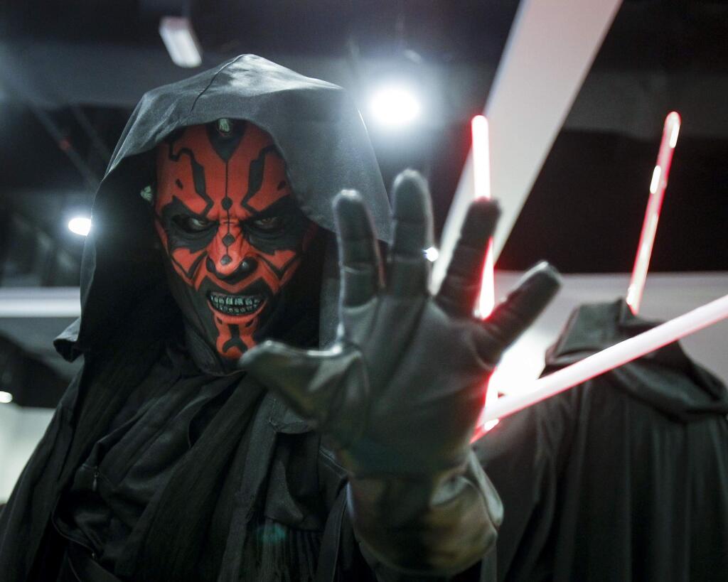 A Star Wars fan dressed as Darth Maul poses for photograph at a Star Wars Day gathering in a mall downtown Kuala Lumpur, Malaysia, Saturday, May 2, 2015. Star Wars Day is observed by fans globally on May 4 with a slight change in the iconic catchphrase; from 'May the Force be with you' to 'May the Fourth be with you'. (AP Photo/Joshua Paul)
