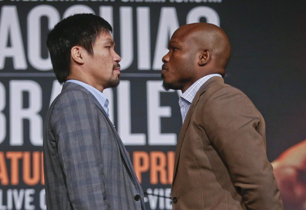 Manny Pacquiao, left, and Timothy Bradley pose for photographs during a news conference to promote an upcoming boxing match Thursday, Jan. 21, 2016, in New York. (AP Photo/Frank Franklin II)