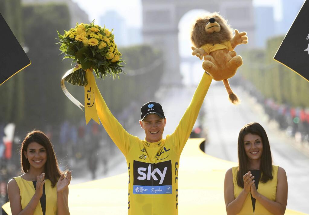 2016 race winner Britain???s Chris Froome, wearing the overall leader???s yellow jersey, celebrates on the podium after the twenty-first stage of the Tour de France cycling race in Paris, France, Sunday, July 24, 2016. (Stephane Mantey Pool via AP)