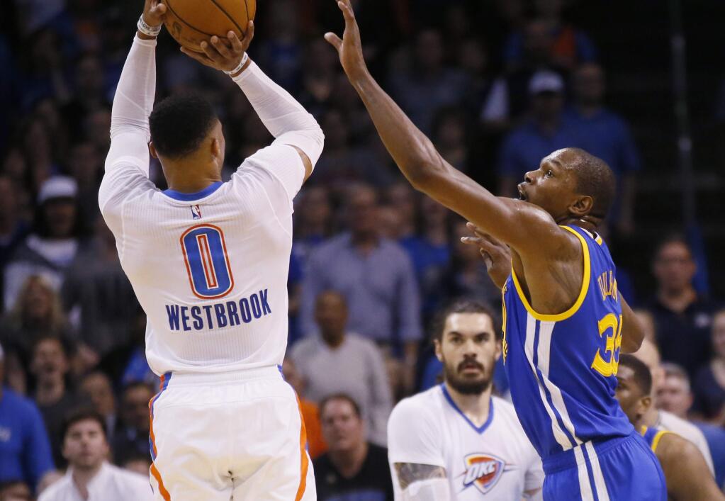 Oklahoma City Thunder guard Russell Westbrook, left, shoots over Golden State Warriors forward Kevin Durant, right, in the first quarter in Oklahoma City, Saturday, Feb. 11, 2017. (AP Photo/Sue Ogrocki)