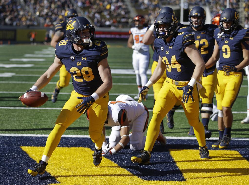 Cal's Patrick Laird, left, celebrates after scoring a touchdown against Oregon State during the first half Saturday, Nov. 4, 2017, in Berkeley.