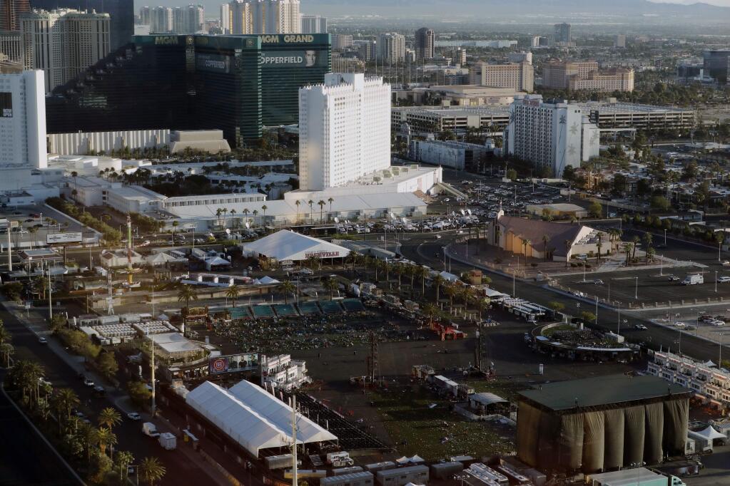 FILE - In this Oct. 3, 2017, file photo, debris litters a festival grounds across the street from the Mandalay Bay resort and casino in Las Vegas. Attorneys who filed one of the first lawsuits after the Oct. 1 mass shooting that killed dozens concert-goers and left hundreds injured on the Las Vegas Strip filed four new negligence cases Monday, Nov. 20, on behalf of more than 450 victims. (AP Photo/Marcio Jose Sanchez, File)