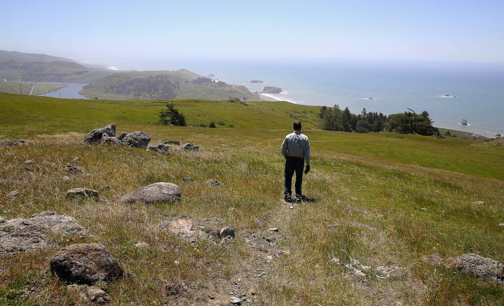 Jenner Headlands Preserve manager Brook Edwards, walks along a trail overlooking the coast, above Jenner, on Thursday, April 28, 2016. (Christopher Chung/ The Press Democrat)
