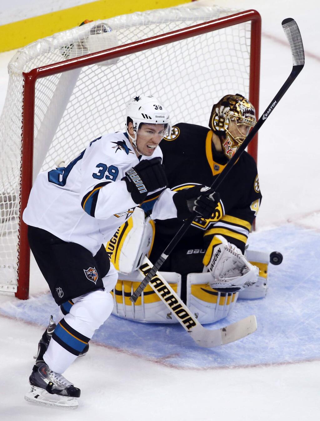 San Jose Sharks center Logan Couture (39) reacts after scoring against Boston Bruins goalie Tuukka Rask during the first period of an NHL hockey game in Boston, Tuesday, Oct. 21, 2014. (AP Photo/Elise Amendola)