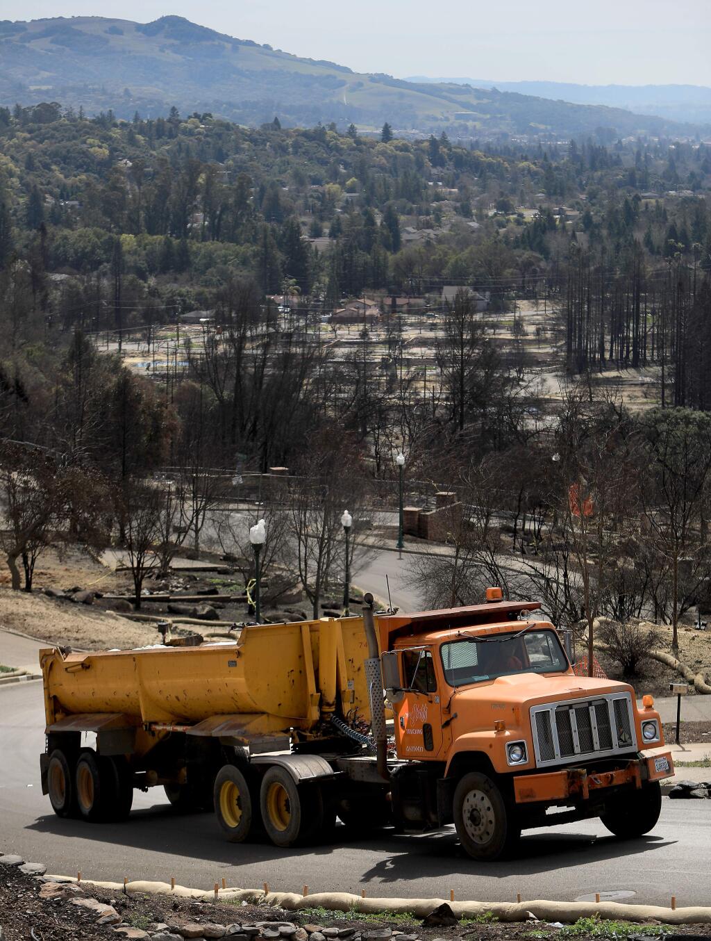 A covered debris truck rolls up the backside of Fountaingrove in Santa Rosa on Tuesday, March 6, 2018. (KENT PORTER/ PD)