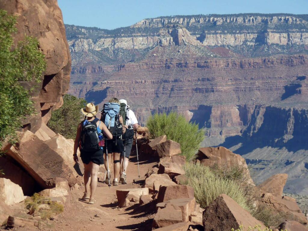 FILE- This Sept. 27, 2010 file photo shows hikers on the South Kaibab Trail in Grand Canyon National Park, Ariz. Be prepared to pay a bit more if youre going to visit some of the national parks and recreation areas this summer. After a six-year moratorium, the federal government has begun increasing the price of admission at some of its public lands and the fees charged for camping, boating, cave tours and other activities. The National Park Service says the money raised is just a fraction of the $11.5 billion needed to fix roads, trails and park buildings. (AP Photo/Carson Walker, file)
