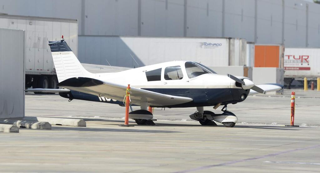 A small airplane sits in a warehouse parking lot Tuesday morning, April 4, 2017, in Whittier, Calif., the day after the pilot, Darrell Roberts, made an emergency landing. California deputies responding to the emergency landing arrested Roberts on suspicion of being under the influence, authorities said Tuesday. (Keith Durflinger/Los Angeles Daily News via AP)
