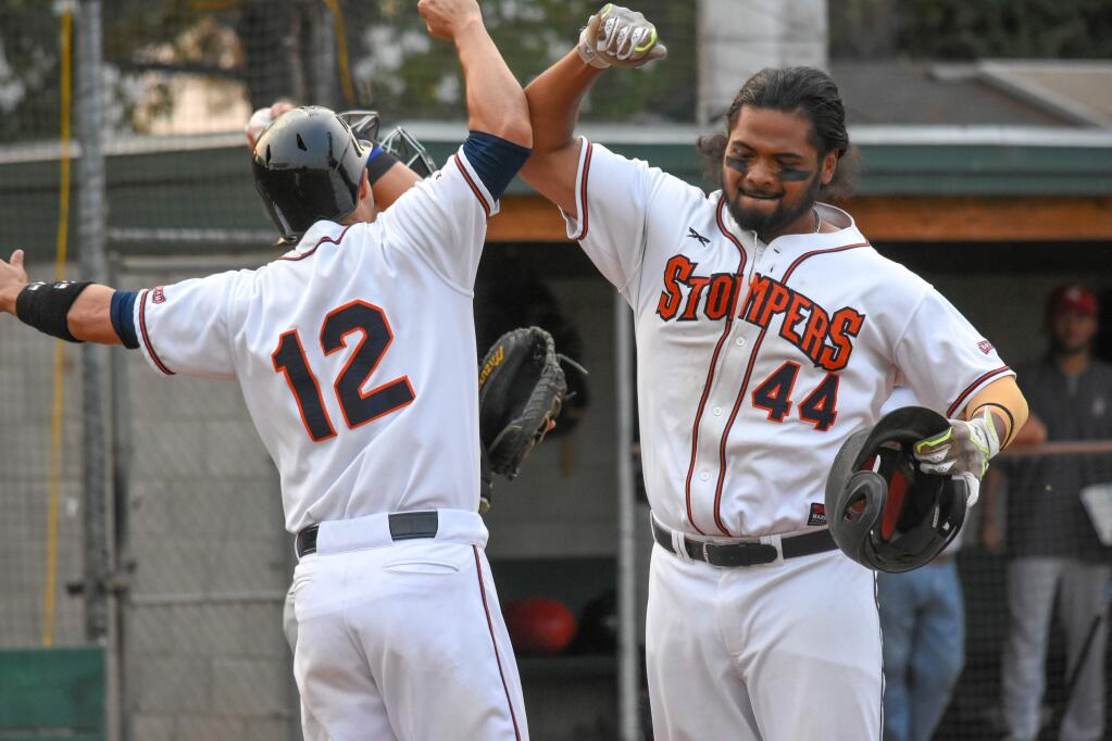 Sonoma's own 'Bash Brothers,' exchange a salute as Daniel Baptista (44) is greeted by Kenny Meimerstorf (12) after hitting his second home run of the day in the third inning of the Sonoma Stompers game against the Napa Silverados, August 7, 2018. (James W. Toy III / Sonoma Stompers)