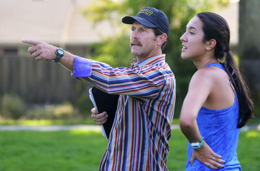 Maria Carrillo cross country coach Greg Fogg talks to runner Aimee Armstrong during practice at Rincon Valley Community Park in Santa Rosa on Monday, Aug. 20, 2018. (Christopher Chung / The Press Democrat)