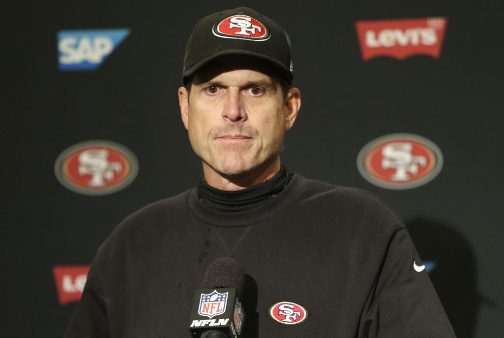 San Francisco 49ers head coach Jim Harbaugh talks to the media after the Seattle Seahawks defeated the 49ers 17-7 in an NFL football game Sunday, Dec. 14, 2014, in Seattle. (AP Photo/John Froschauer)