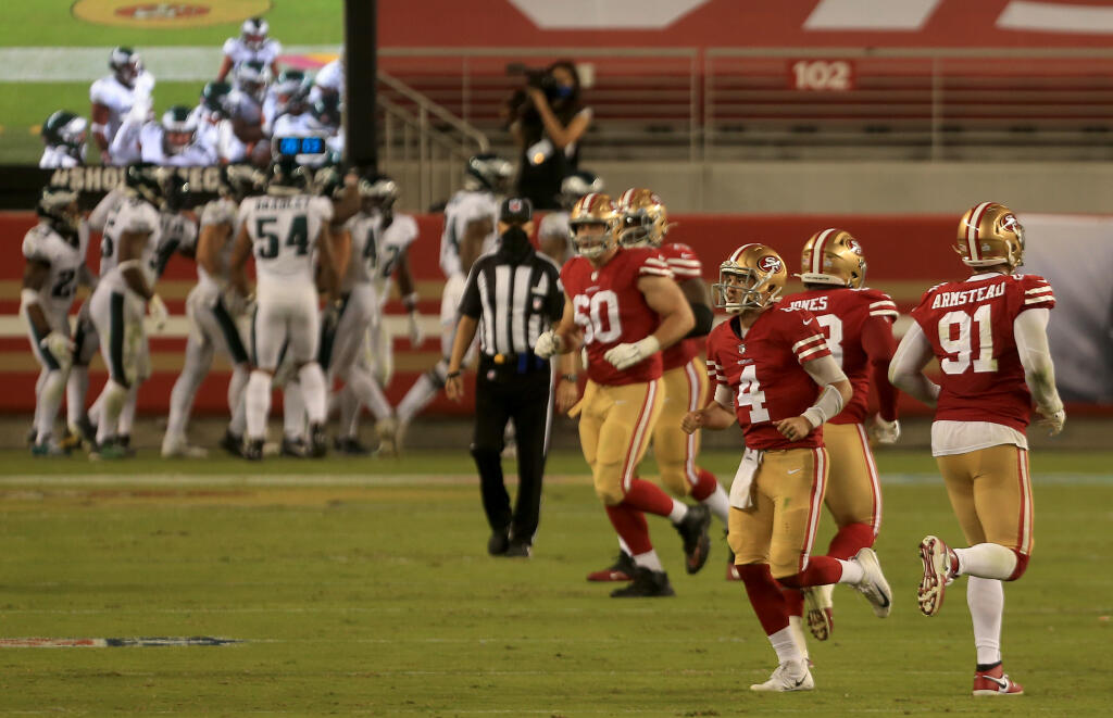 Nick Mullens runs unceremoniously from the field after throwing a pick six late in the fourth quarter during San Francisco's 25-20 loss to Philadelphia, Sunday, Oct. 4, 2020 in Santa Clara. (Kent Porter / The Press Democrat) 2020