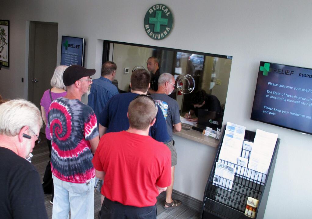 FILE - In this July 31, 2015, file photo, people line up to be among the first in Nevada to legally purchase medical marijuana at the Silver State Relief dispensary in Sparks, Nev. Nevada voters legalized recreational marijuana in November, and officials are trying to put rules in place to start selling it on July 1, 2017. (AP Photo/Scott Sonner, File)