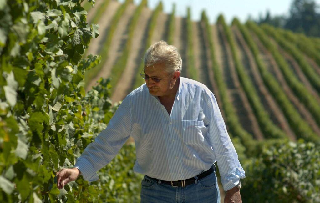 Don Carano, gaming patriarch and co-owner of PreVail Mountain Winery Estate in Healdsburg, inspects grape clusters in a RockRise Mountain vineyard in the Alexander Valley a few weeks before the 2006 harvest. (Photo by: Liz Margerum)