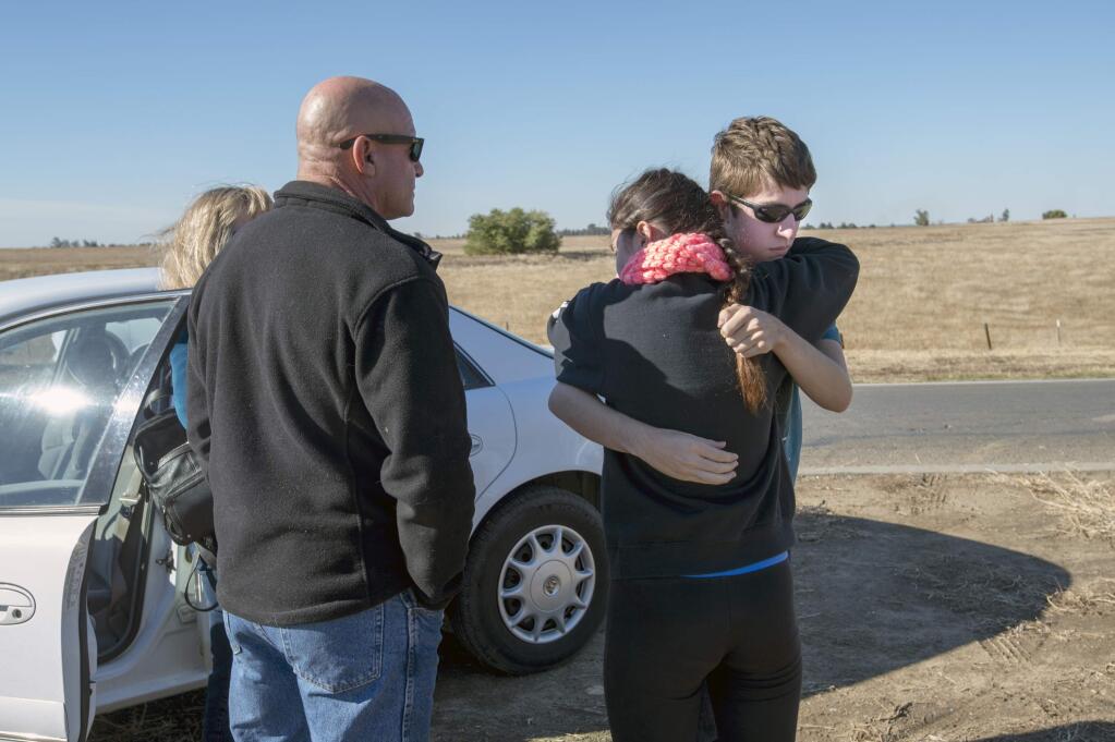 FILE - In this Wednesday, Nov. 4, 2015, file photo, University of California, Merced student Justin Dick, right, hugs his sister Kristen as his parents Beth and Keith look on following a stabbing in Merced, Calif. An assailant stabbed five people at the rural university campus in central California before police shot and killed him, authorities said Wednesday. Justin was one of 15 students in the core class where the incident took place Wednesday morning. A California university student who went on a campus stabbing rampage that wounded four people before he was shot down by a campus police officer was inspired by Islamic State but acted alone, the FBI said Thursday, March 17, 2016. (Paul Kitagaki Jr./The Sacramento Bee via AP, File) MAGS OUT; LOCAL TELEVISION OUT (KCRA3, KXTV10, KOVR13, KUVS19, KMAZ31, KTXL40); MANDATORY CREDIT (REV-SHARE) (ONLN OUT; IONLN OUT - MBI)