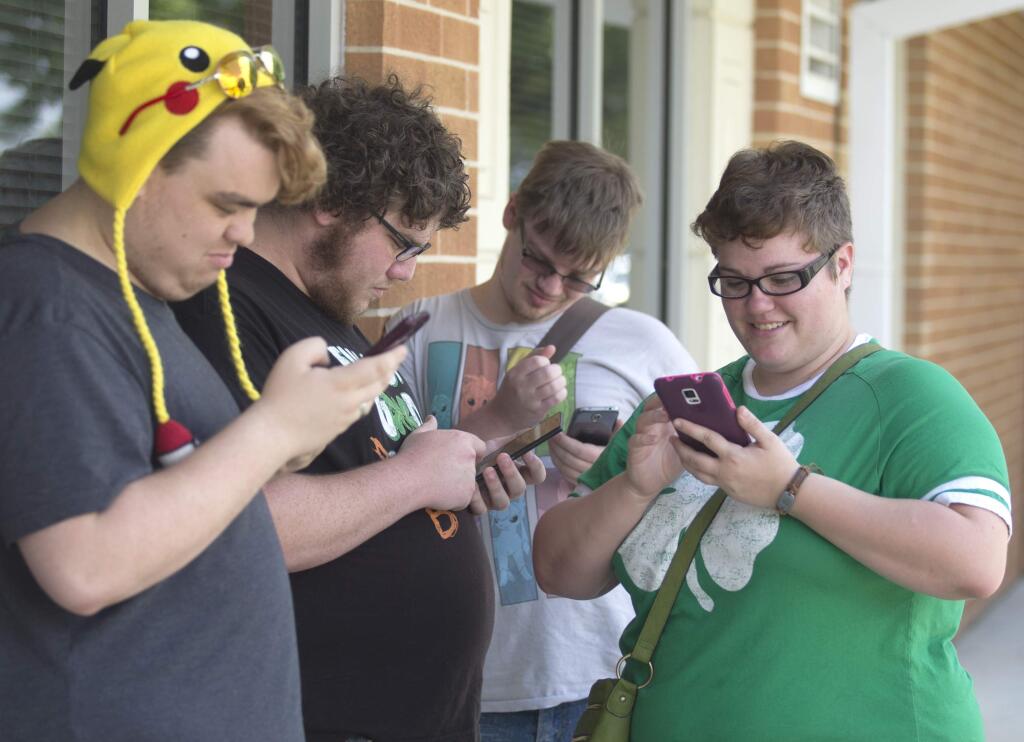 Chase Brown, Keith Harrell, Christopher Van Avery and Alex Hicks play 'Pokemon Go' as Gulf Coast State College in Panama City, Fla. hosted a 'Pokemon Go.' (PATTI BLAKE / News Herald)
