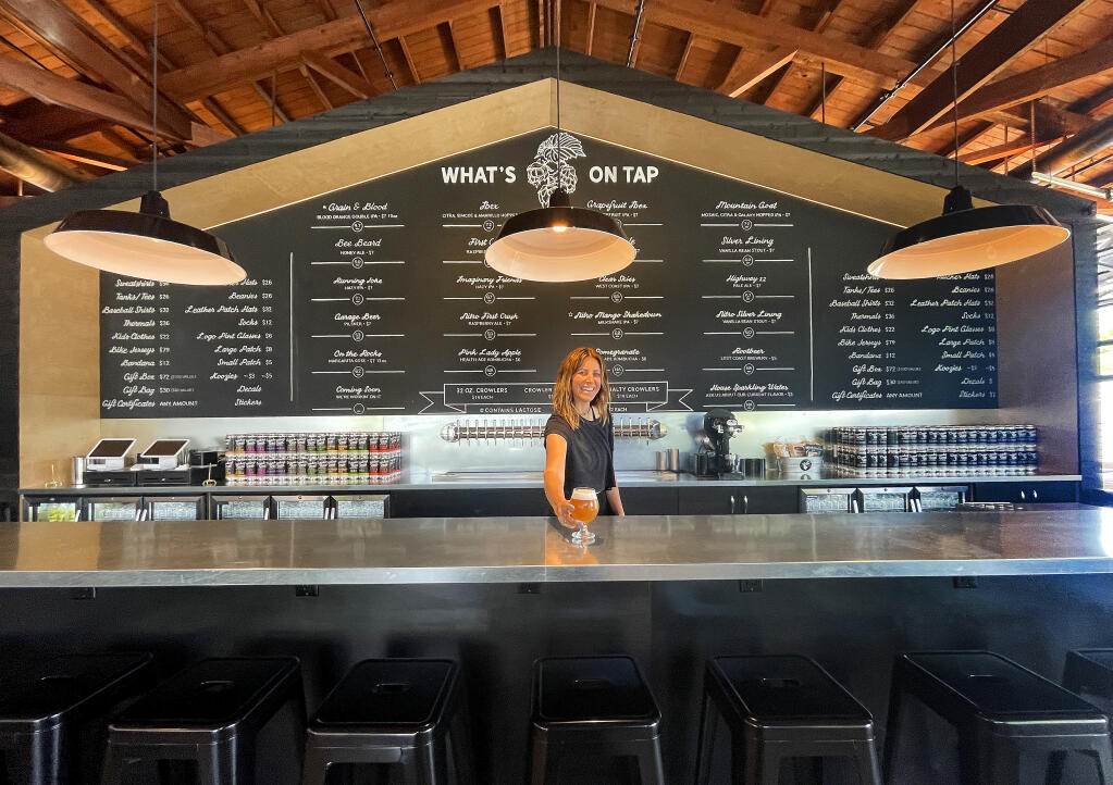 Karly Church serves up a beer at the new Crooked Goat Brewing taproom on Howard St. in Petaluma on May 17, 2022. (John Burgess/The Press Democrat)