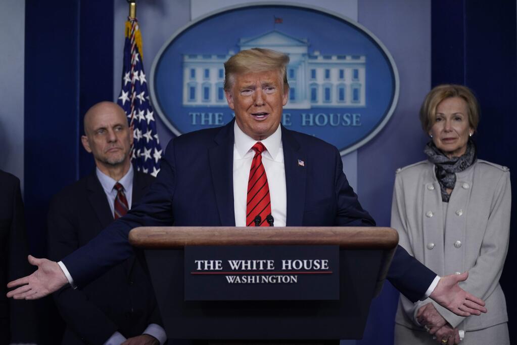 President Donald Trump speaks during press briefing with the coronavirus task force, at the White House, Thursday, March 19, 2020, in Washington. Food and Drug Administration Commissioner Dr. Stephen Hahn, at left, and Dr. Deborah Birx, White House coronavirus response coordinator, at right listen. (AP Photo/Evan Vucci)