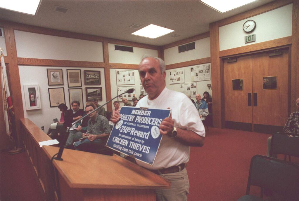 Jerry Marino addresses the Sonoma City Council on the subject of chickens in the Plaza, in 1999; he holds a sign that he said would help keep the chickens safe, and raise revenue for the city. (Press Democrat file)