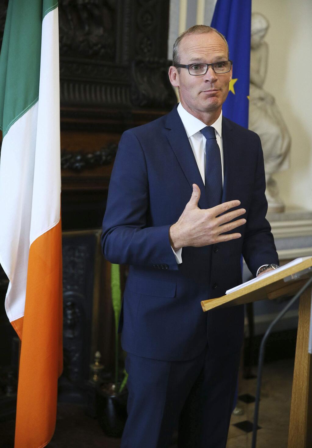Ireland's Foreign Affairs Minister, Simon Coveney, speaks to the media, at Iveagh House in Dublin, in response to the UK Government's Brexit proposals, Wednesday Aug. 16, 2017. Britain said there must be no border posts or electronic checks between Northern Ireland and the Irish republic after Brexit, and it committed itself to maintaining the longstanding, border-free Common Travel Area covering the U.K. and Ireland. (Brian Lawless/PA via AP)