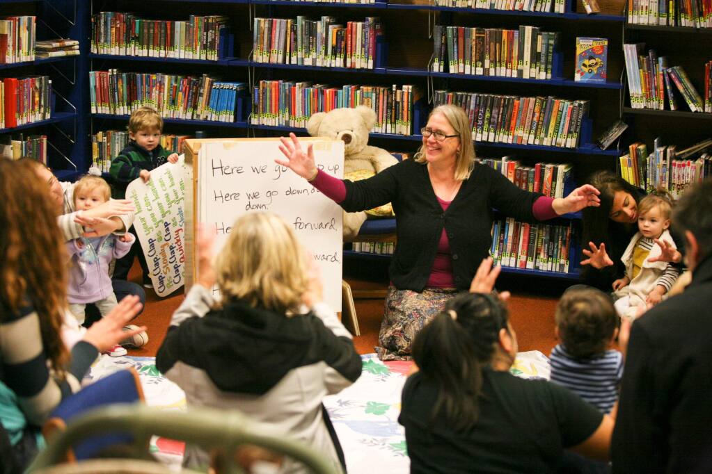 Children's Librarian Kate Keaton leads a babytime program at the Petaluma Regional Library on Wednesday morning, December 10, 2014. (SCOTT MANCHESTER/ARGUS-COURIER STAFF)