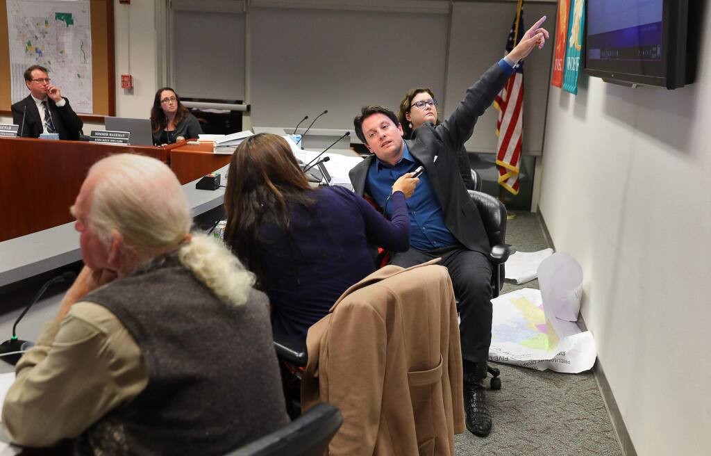 Windsor Mayor Dominic Foppoli, center, vice mayor Deborah Fudge, right, and councilmembers Esther Lemus and Sam Salmon work on creating new district lines during a Town Council meeting in Windsor on Monday, Feb. 25, 2019. (Christopher Chung/ The Press Democrat, 2019)