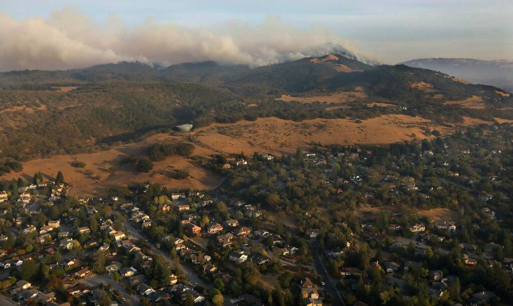 Fire makes its way over Bennett Ridge towards Annadel Heights in Santa Rosa. (photo by John Burgess with Helico/The Press Democrat)