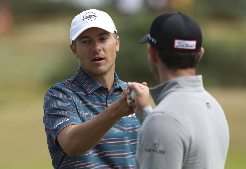 Jordan Spieth of the US, left, touches fists with Patrick Cantlay of the US during a practice round ahead of the British Open Golf Championship in Carnoustie, Scotland, Wednesday July 18, 2018. (AP Photo/Jon Super)