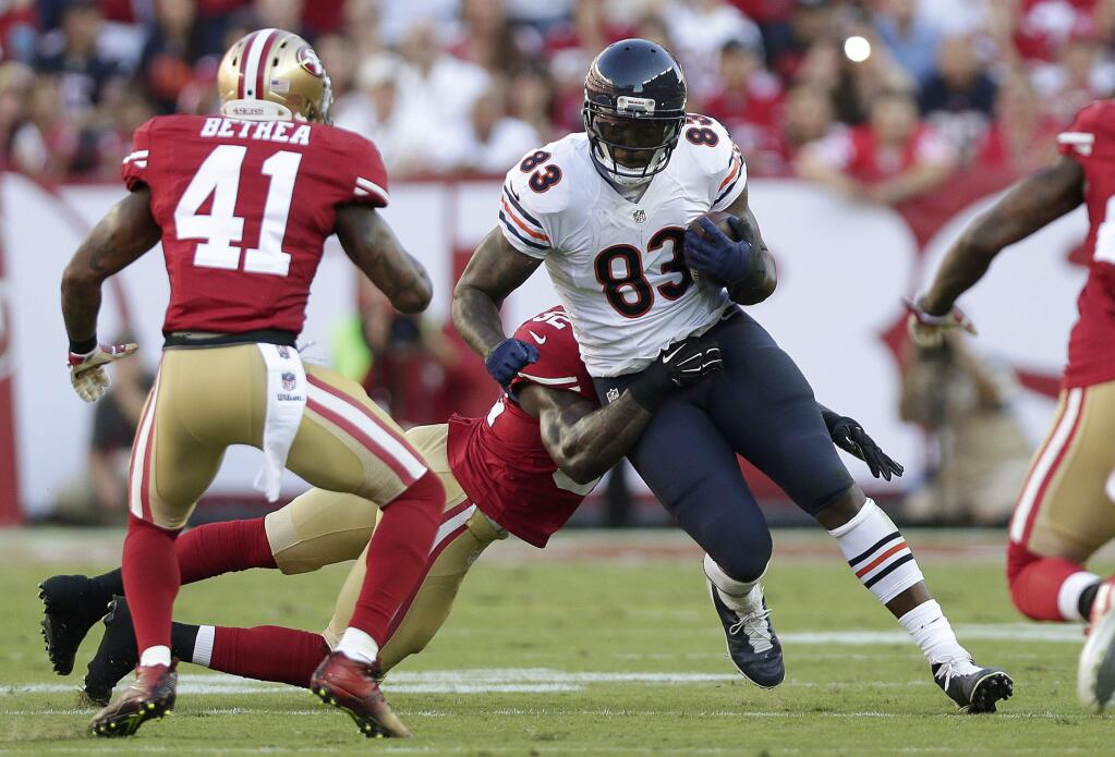 Chicago Bears tight end Martellus Bennett (83) tries to run from San Francisco 49ers linebacker Patrick Willis, rear, as strong safety Antoine Bethea (41) waits to assist during the first quarter of an NFL football game in Santa Clara , Sept. 14, 2014. (AP Photo/Marcio Jose Sanchez)