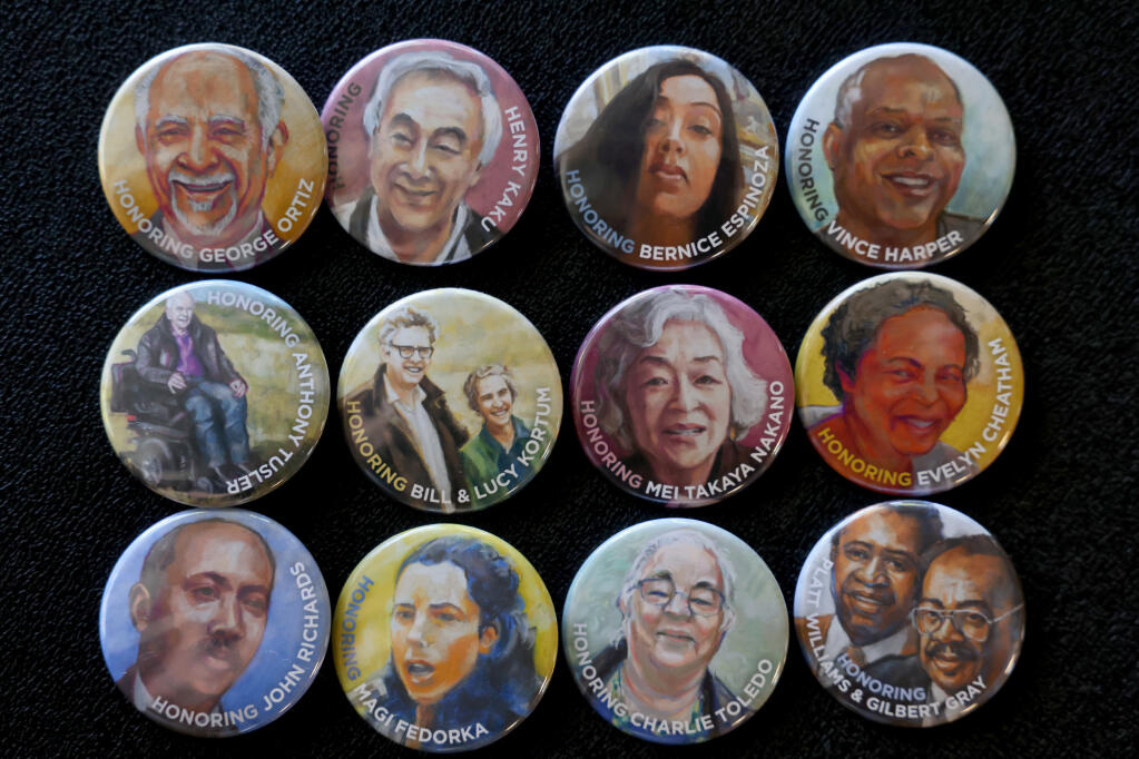 Buttons featuring the portraits of 14 local activists featured in the new “Claiming Justice” public art walking trail, were handed out at the launch event at the downtown public library in Santa Rosa on Sunday, Oct. 29, 2023. (Beth Schlanker / The Press Democrat)