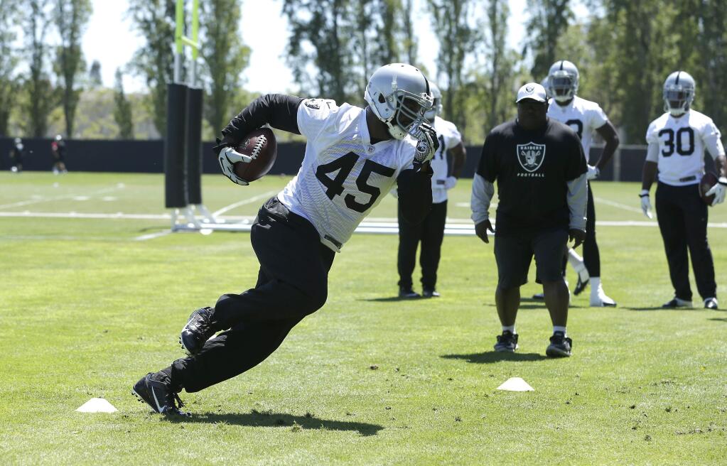 Oakland Raiders fullback Marcel Reece carries the ball during the Raiders minicamp in Alameda, Calif., Tuesday, June 17, 2014.(AP Photo/Rich Pedroncelli)