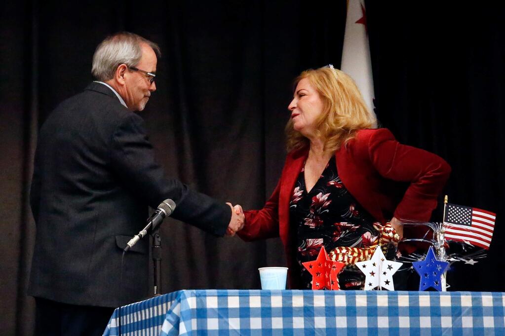 The candidates for Sonoma County District 3 supervisor, incumbent Shirlee Zane, right, and challenger Chris Coursey, shake hands before the start of their debate at Veterans Memorial Hall in Santa Rosa, California, on Wednesday, January 22, 2020. (Alvin Jornada / The Press Democrat)