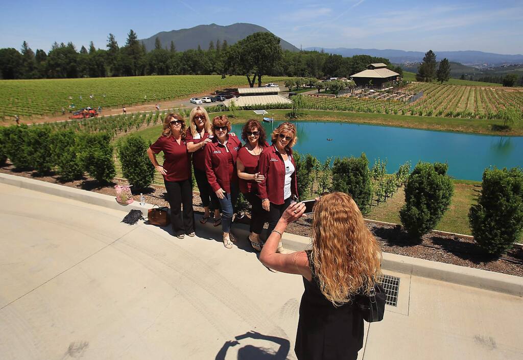 At the Northern and Central California Chamber Ambassador Rally at Boatique Winery in Kelseyville, Denise Rockenstein of Clear Lake Chamber of Commerce photographs, from left, Nicole Arabia, Judi Navarro, Cheryl Bovee, Jaye Lovelace and Denise Smith. Mt. Konocti is in the background Friday May 13, 2016. (Kent Porter / Press Democrat) 2016