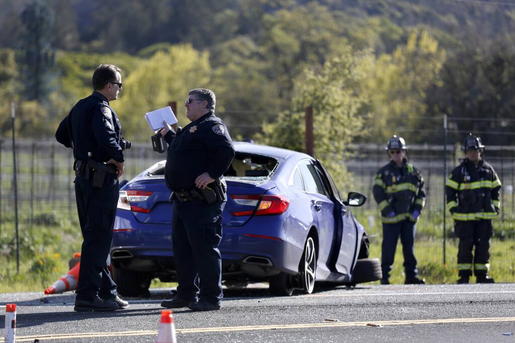 CHP and Santa Rosa firefighters work at the scene of a fatal accident involving a tree-trimming truck and a blue Honda Civic at the intersection of Hwy 12 and Oakmont Drive in Santa Rosa on Thursday, April 2, 2020. (BETH SCHLANKER/ The Press Democrat)
