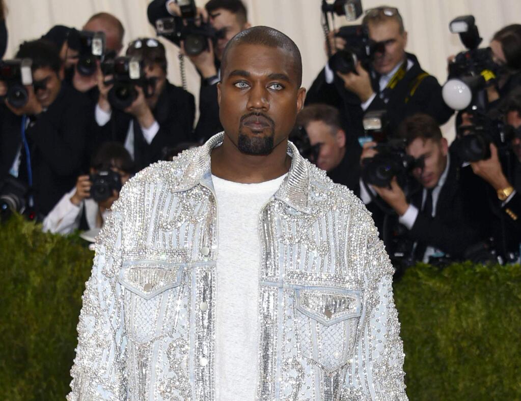 FILE - In this May 2, 2016 file photo, Kanye West arrives at The Metropolitan Museum of Art Costume Institute Benefit Gala, celebrating the opening of 'Manus x Machina: Fashion in an Age of Technology' in New York. West was taken to Ronald Reagan UCLA Medical Center in Los Angeles on Monday, Nov. 21, for stress and exhaustion. (Photo by Evan Agostini/Invision/AP)