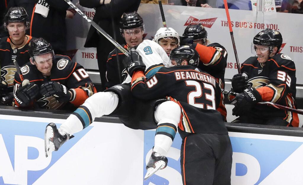 Anaheim Ducks defenseman Francois Beauchemin, right, checks San Jose Sharks left wing Evander Kane into the bench during the first period of Game 2 of their first-round playoff series in Anaheim, Saturday, April 14, 2018. (AP Photo/Chris Carlson)