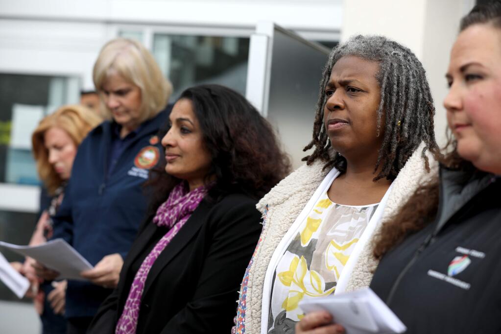 Barbie Robinson, (second from right) the director of the Department of Health Services, and Dr. Sundari Mase, the health officer, attend a press conference about the first community spread case of the coronavirus and the local response. Photo taken outside the Sonoma County administration building in Santa Rosa on Sunday, March 15, 2020. (BETH SCHLANKER/ The Press Democrat)