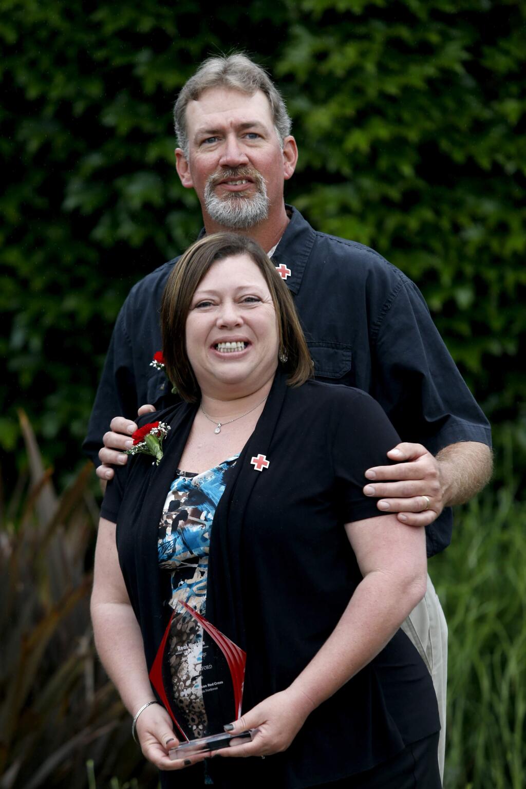 Lisa Lunsford and her husband Troy were honored as the Act of Courage Heros for saving the lives of two elderly women who needed to be rescued from their homes during the Valley Fire. Photo taken at the Red Cross's 13th Annual Real Heroes breakfast at the DoubleTree in Rohnert Park, on Thursday, April 21, 2016. (BETH SCHLANKER/ The Press Democrat)