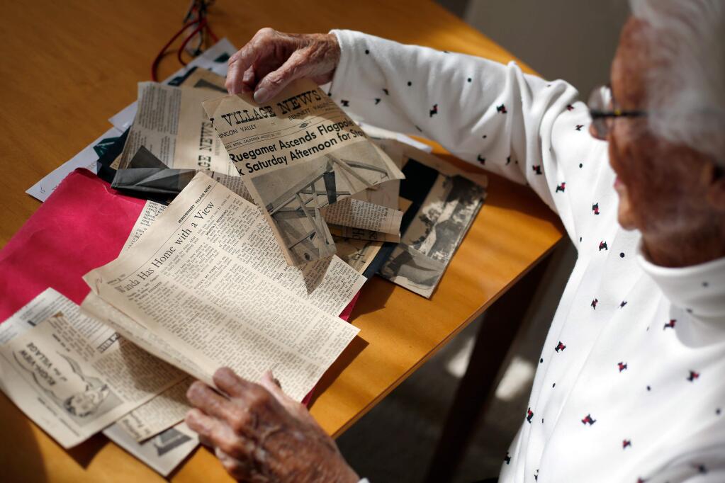 Wanda Ruegamer looks through newspaper clippings from 1951 featuring stories about her living atop a Montgomery Village flagpole for 21 days, at her home in Santa Rosa, California, on Thursday, March 29, 2018. (Alvin Jornada / The Press Democrat)