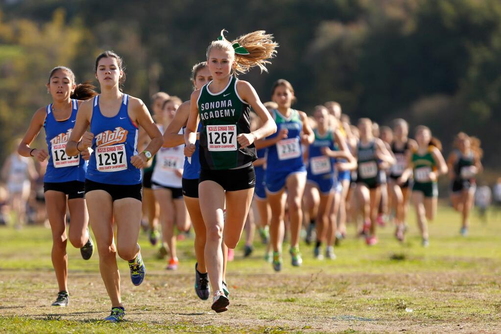 Sonoma Academy's Rylee Bowen, center, starts with an early lead in front of the Division V girls race during the NCS Cross Country championship races in Hayward, California on Saturday, November 21, 2015. Bowen finished first in her division with a 17:29.7 time. (Alvin Jornada / The Press Democrat)
