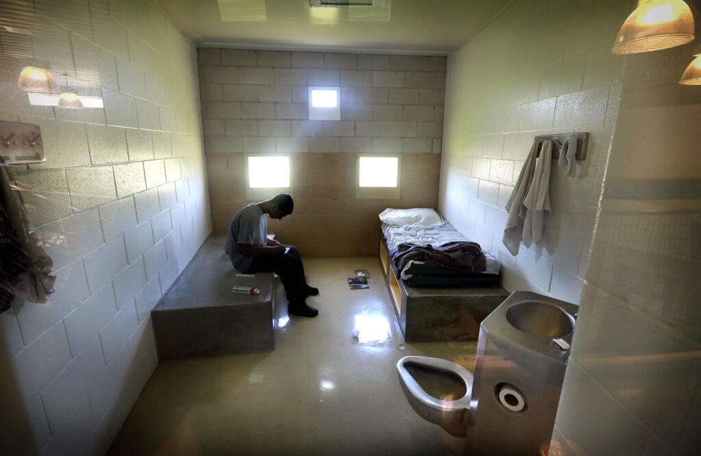 A teen inmate spends his quiet time after lunch reading in his cell in the Sonoma County Juvenile Hall in 2017. (JOHN BURGESS/ PD)