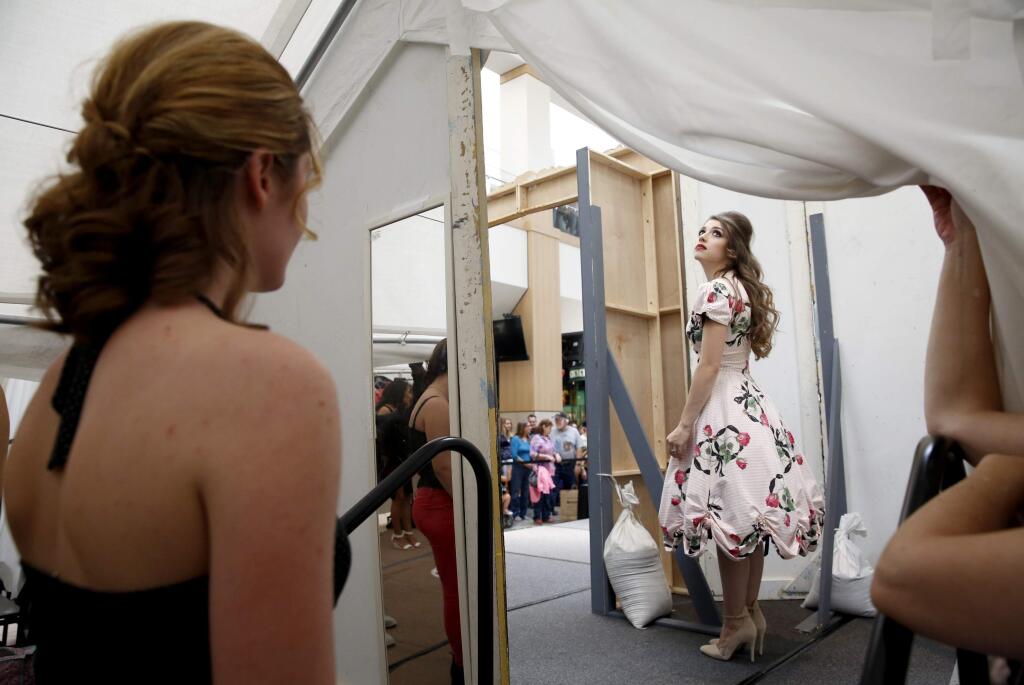 Hannah Maffia waits to go onstage in a 1950s inspired dress during the Santa Rosa Junior College fashion show at Santa Rosa Plaza in Santa Rosa, on Sunday, April 26, 2015. (BETH SCHLANKER/ The Press Democrat)