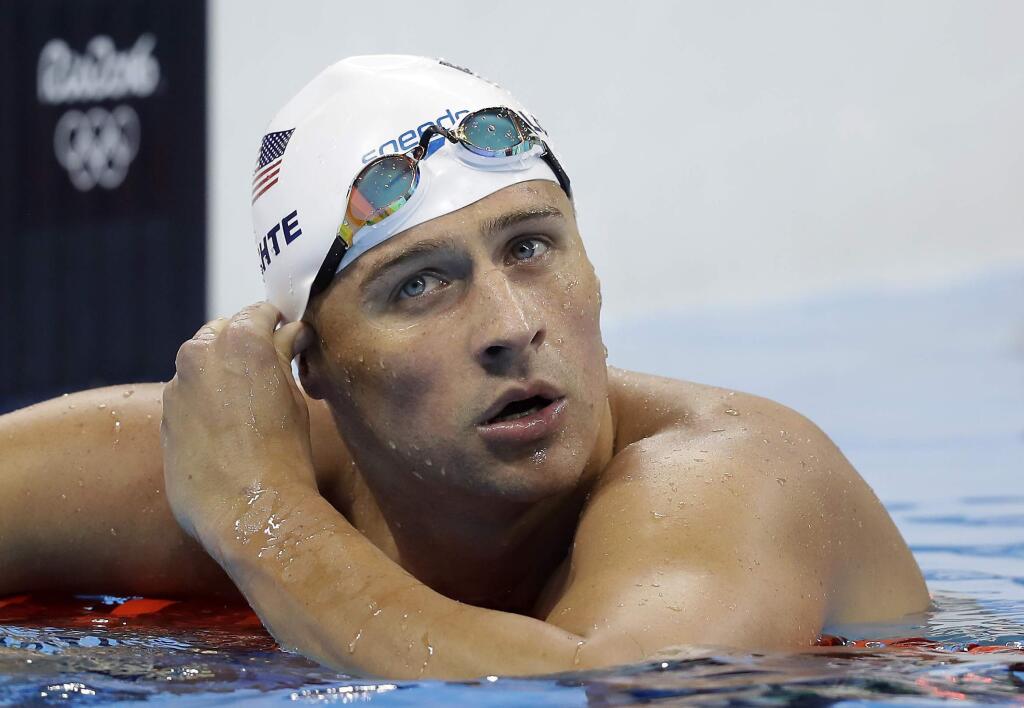 FILE - In this Tuesday, Aug. 9, 2016, file photo, United States' Ryan Lochte checks his time in a men's 4x200-meter freestyle heat at the 2016 Summer Olympics, in Rio de Janeiro, Brazil. Lochte has been suspended until July 2019 by the U.S. Anti-Doping Agency. The 12-time Olympic medalist has been sanctioned for getting an intravenous infusion, a method that broke anti-doping rules. U.S. officials say Lochte was not using a banned substance. But under anti-doping rules, athletes typically cannot receive IVs unless related to a hospitalization or through an exemption. Lochte posted a photo of himself getting the IV in May and that image prompted the investigation. He was entered in four events at the national championships that start Wednesday, July 25, 2018, in California. (AP Photo/Michael Sohn, File)