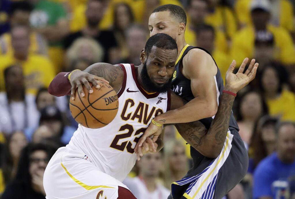 FILE - In this June 3, 2018, file photo, Cleveland Cavaliers forward LeBron James (23) drives against Golden State Warriors guard Stephen Curry during the first half of Game 2 of basketball's NBA Finals in Oakland, Calif. James is signing as a free agent with the Los Angeles Lakers, leaving the Cavaliers for the second time to join one of the NBA's most iconic franchises. James made the announcement Sunday, July 1, 2018, on a release, saying he has agreed to a four-year, $154 million contract. (AP Photo/Marcio Jose Sanchez, File)
