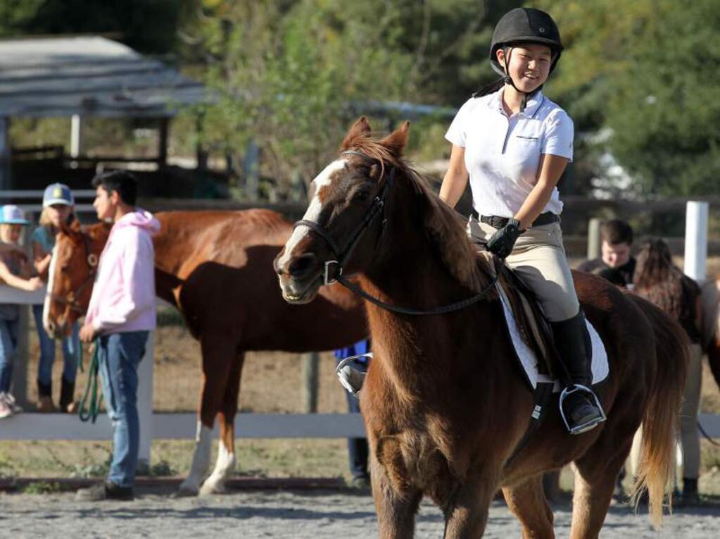 Martha Ockpenfuss, 16, says riding and exercising Mr. McGoo, a 22-year-old Arabian horse, has helped her deal with emotional issues and feelings of inadequacy.