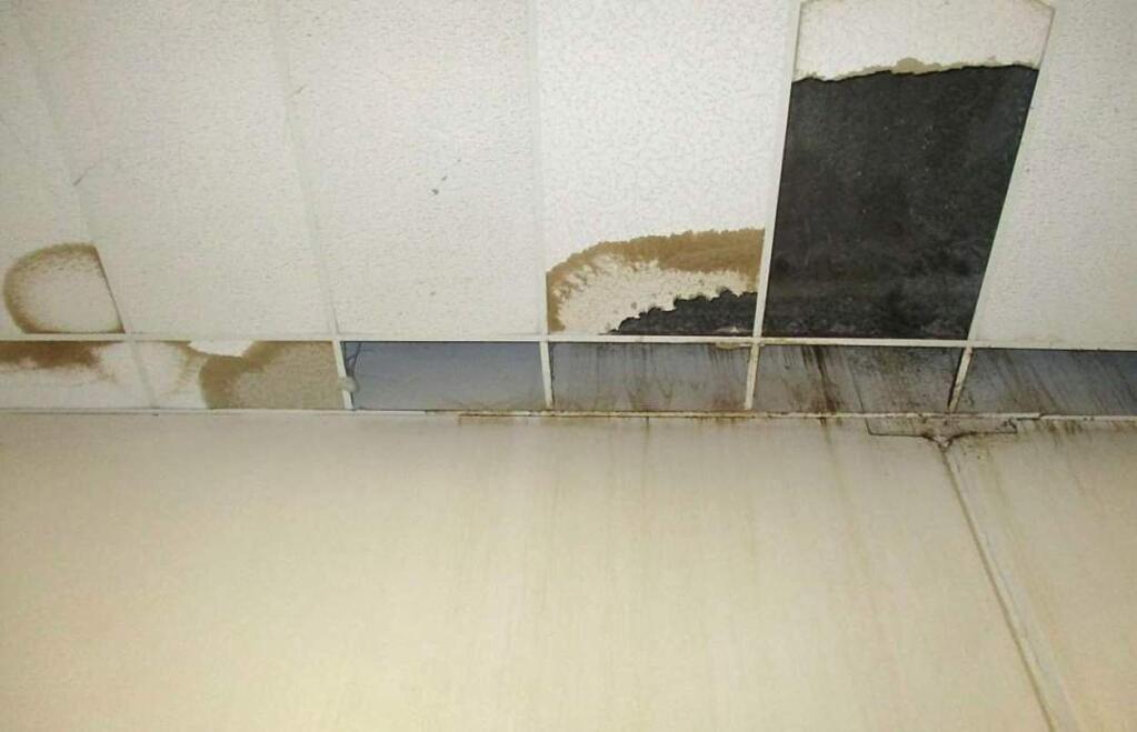 In this undated photo provided by the Prison Law Office, a non-profit public interest law firm that provides free legal services to prison inmates, is the front wall and ceiling of a dining hall where damaged ceiling tiles have been removed at the California Substance Abuse Treatment Facility and State Prison in Corcoran, Calif. California is spending $260 million over four years to repair leaking roofs and clear dangerous mold that imperils more than two-dozen deteriorating prisons. An inmate lawsuit over the conditions says the repairs aren't moving fast enough. (Prison Law Office via AP)