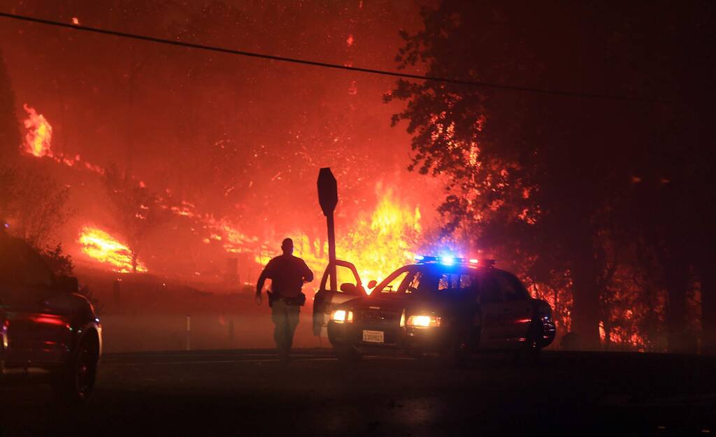 Lake County SO prepare to evacuate Butts Canyon Road in Middletown as the Valley fire jumps hwy 29. Saturday Sept. 12, 2015. (Kent Porter / Press Democrat) 2015