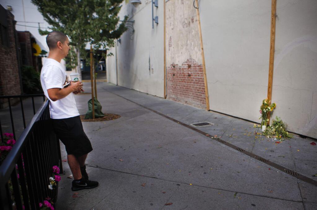 Petaluma, CA, USA. Tuesday, September 12, 2017._Santiago Nuñez, 36, the older brother of Cristian Nuñez, the 24-year-old who was stabbed and died of his wounds after an altercation in downtown Petaluma, visits the makeshift memorial placed near the Keller Street parking lot. (CRISSY PASCUAL/ARGUS-COURIER STAFF)
