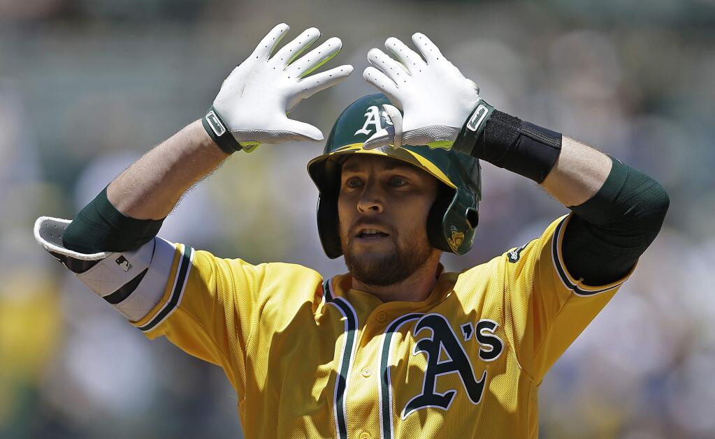 The Oakland Athletics' Jed Lowrie celebrates after hitting a two-run home run off the Washington Nationals' Joe Ross in the first inning Saturday, June 3, 2017, in Oakland. (AP Photo/Ben Margot)